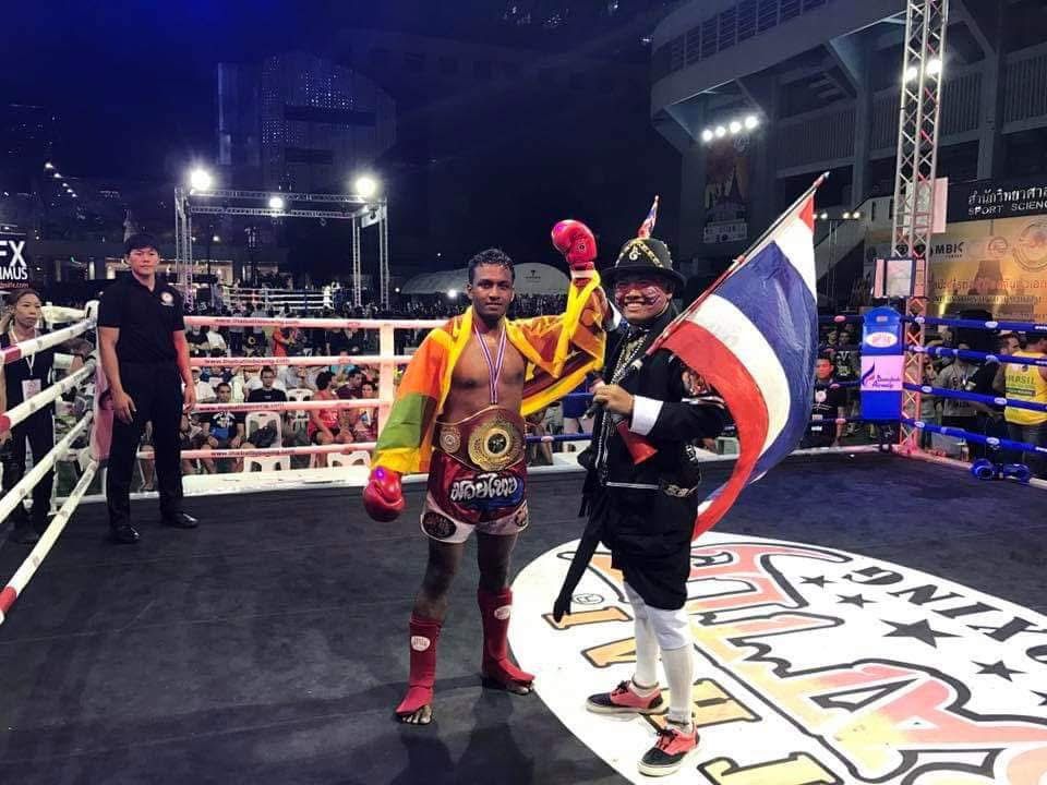 Nilanka Madushan celebrating with the championship belt in the ring