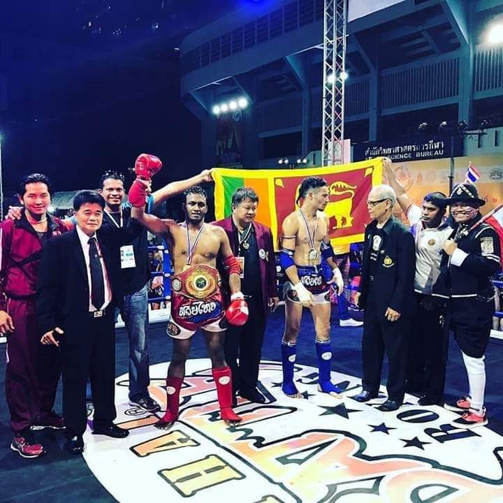Nilanka Madushan with officials and the Sri Lankan flag