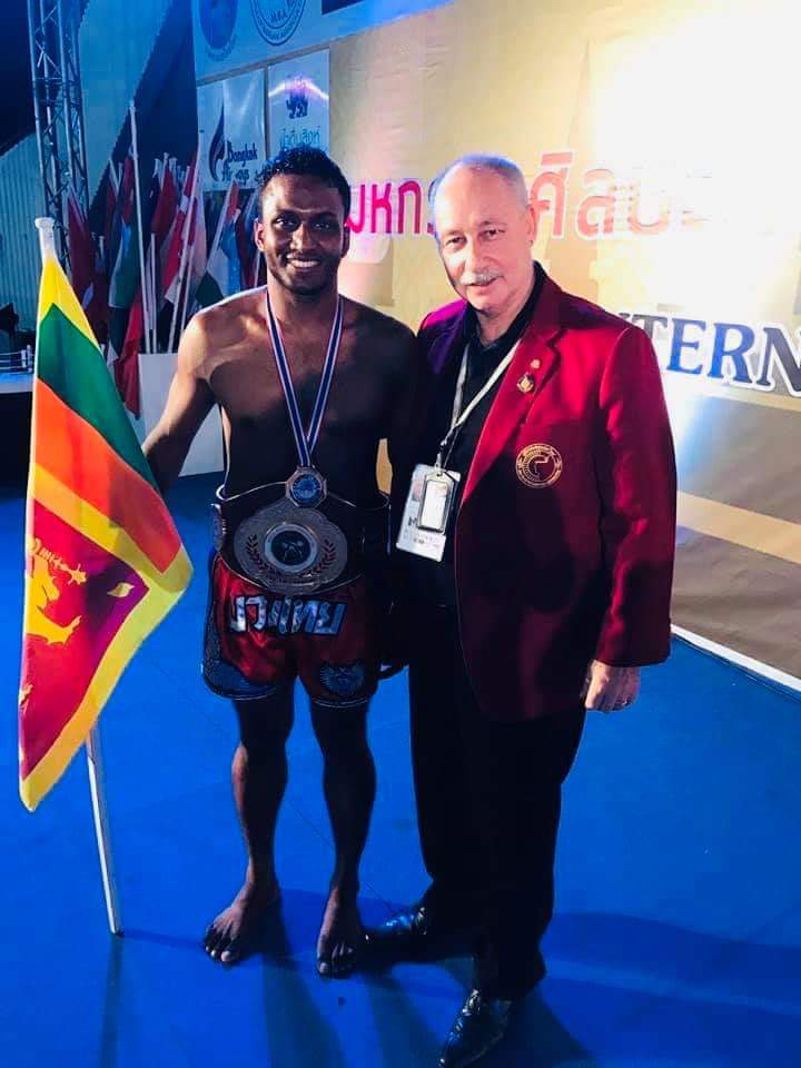 Nilanka Madushan with the championship belt and a WMO official