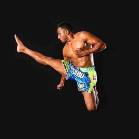 Coach Nilanka Madushan executing a flying knee in Muay Thai